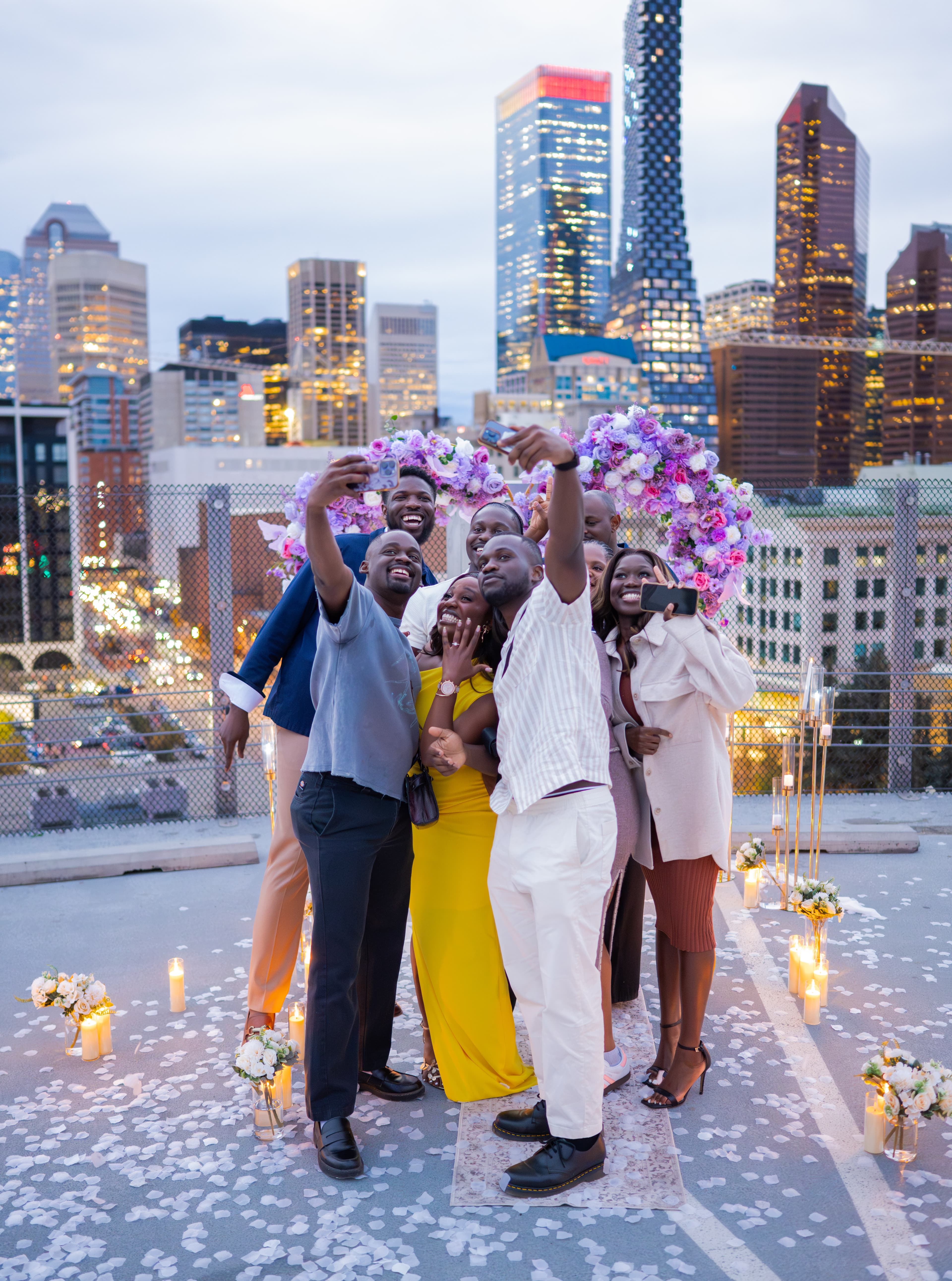 Juwon and Femi with friends on a rooftop evening